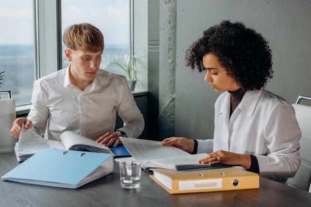 man and woman reading professionnal report on a paper